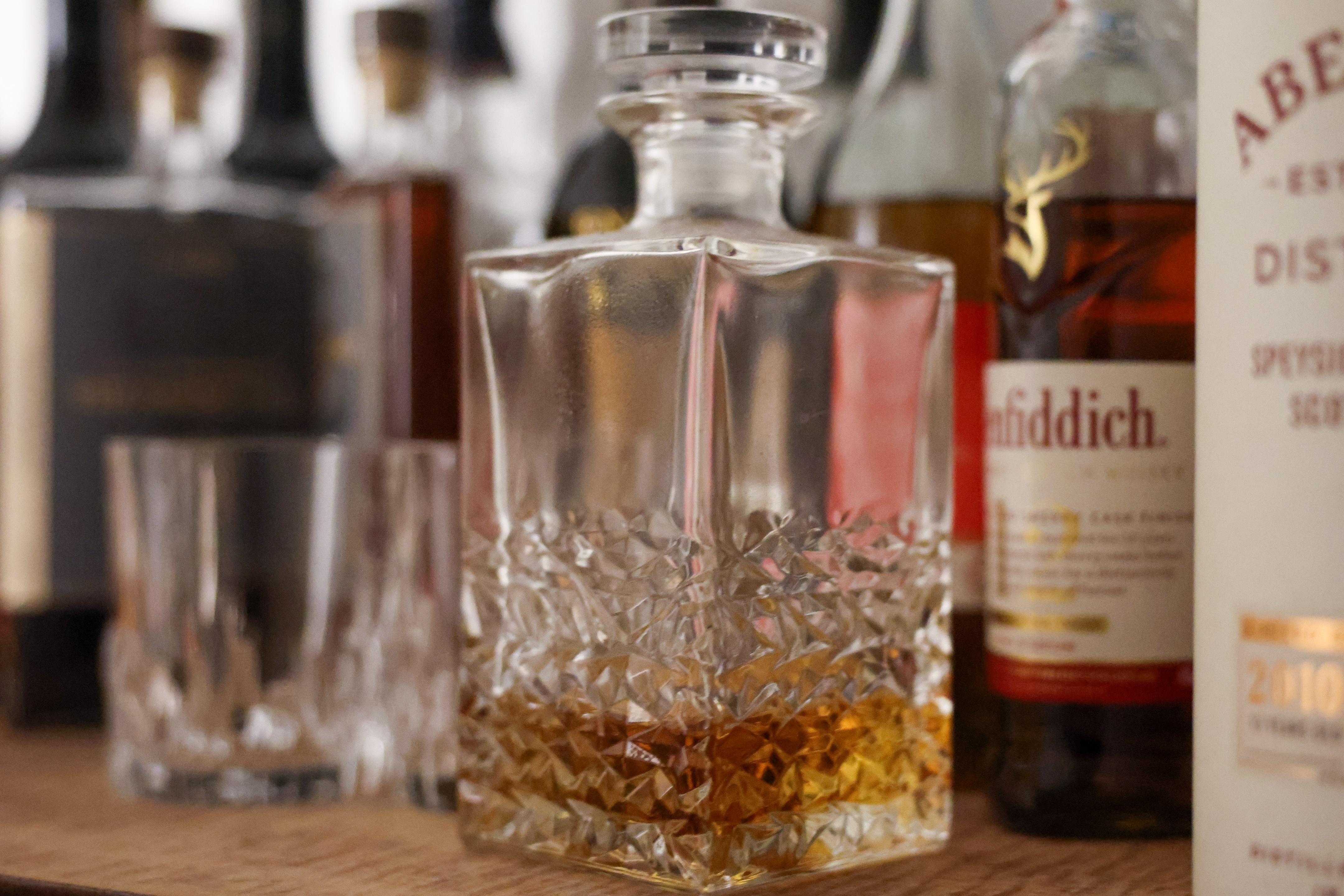 A whisky decanter on a bar top shot at ISO 12,800