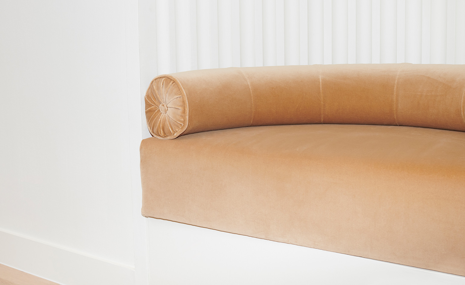 White wall with round sofa