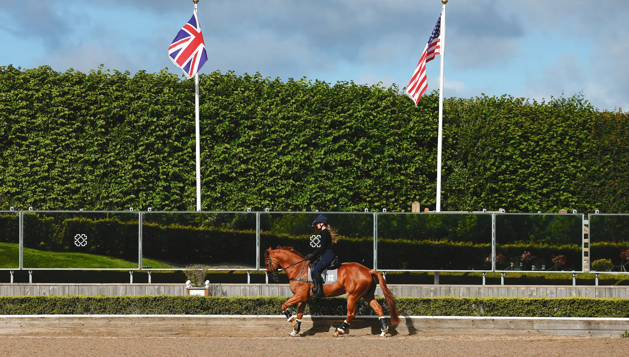 Cosby Green with Jos UFO de Quidam with the Union Jack and USA flag flying in the background at Chedington Equestrian Centre