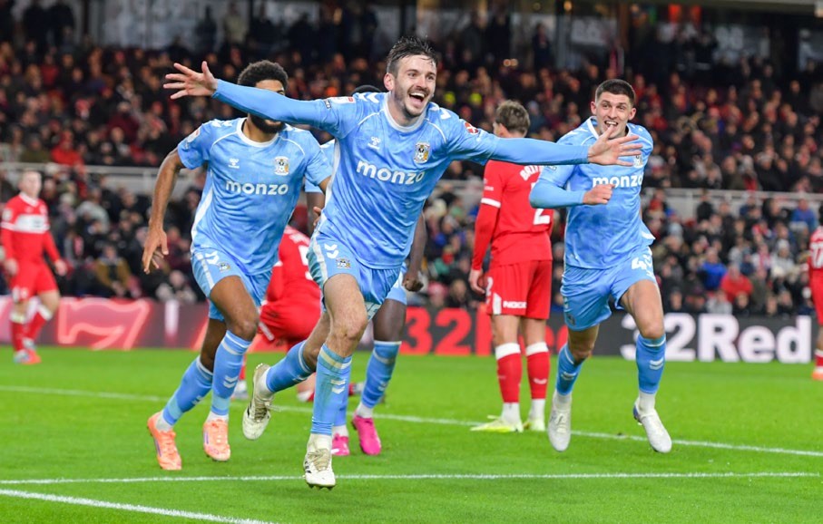 Coventry players running, celebrating.