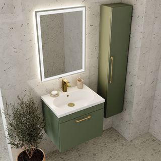 Small bathroom with green vanity unit and tall storage unit and brass hardware