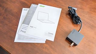 Manuals and USB-C power cable that comes with Acer Swift 14 AI.