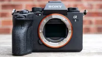 The Sony A1, one of the most powerful mirrorless cameras ever, sitting on a wooden surface without a lens