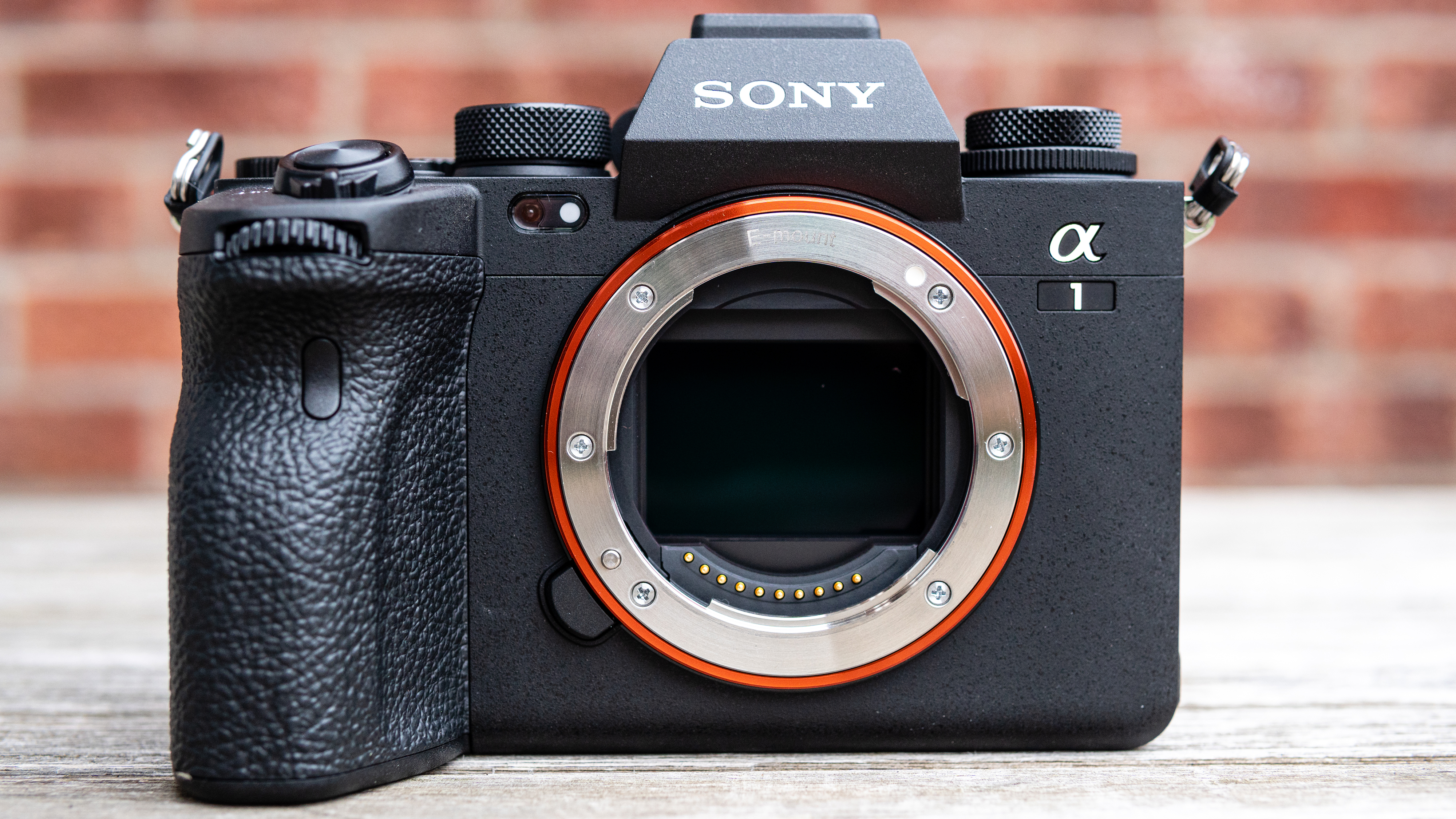 The Sony A1 sitting on a wooden table in front of a wall