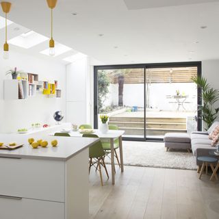 white kitchen with worktop and dining table