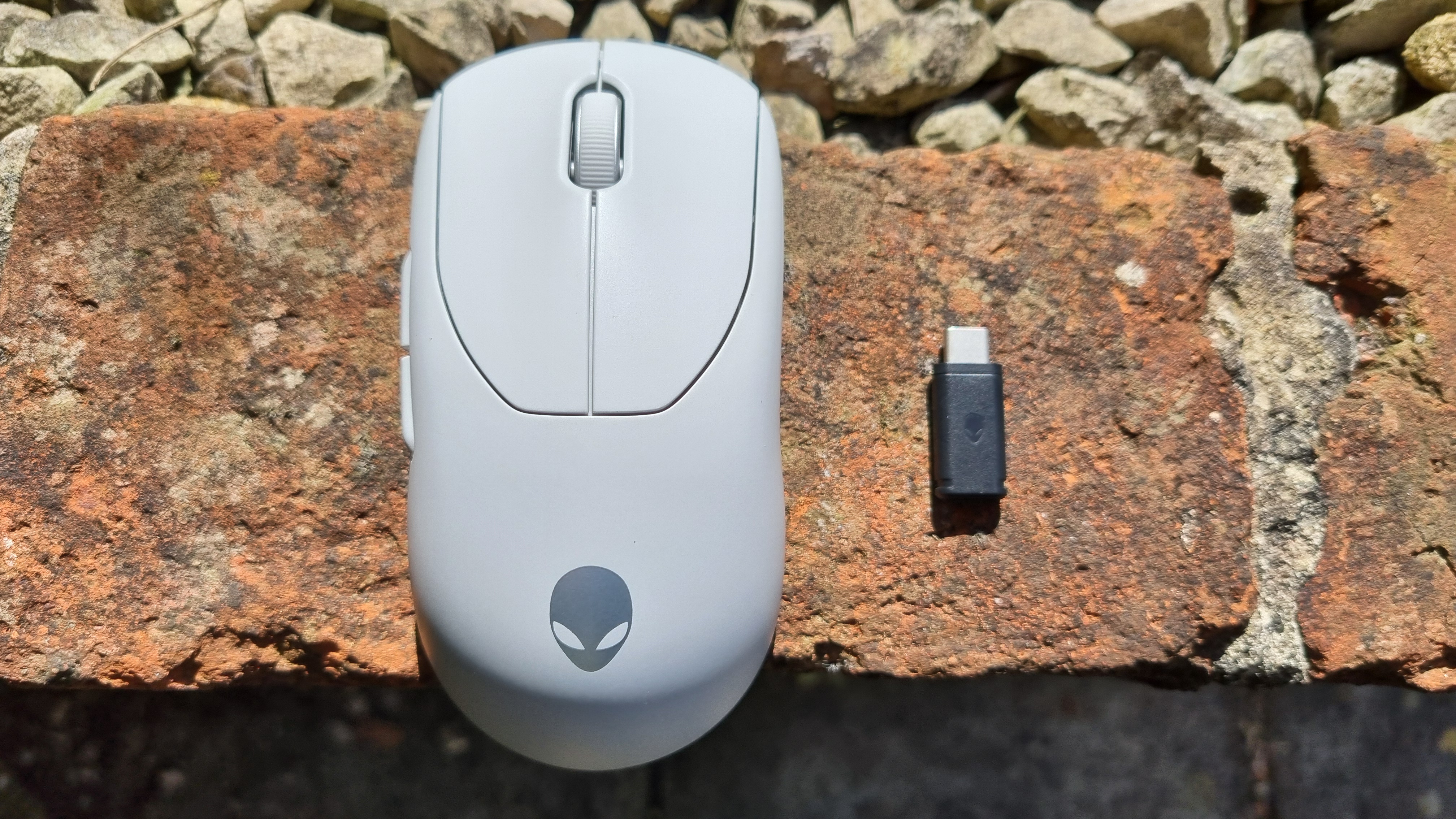 The Alienware Pro Wireless Gaming Mouse, side by side with its wireless receiver