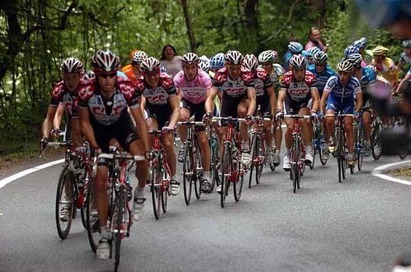 The CSC army rolls forward with their leader Ivan Basso safely inside the convoy