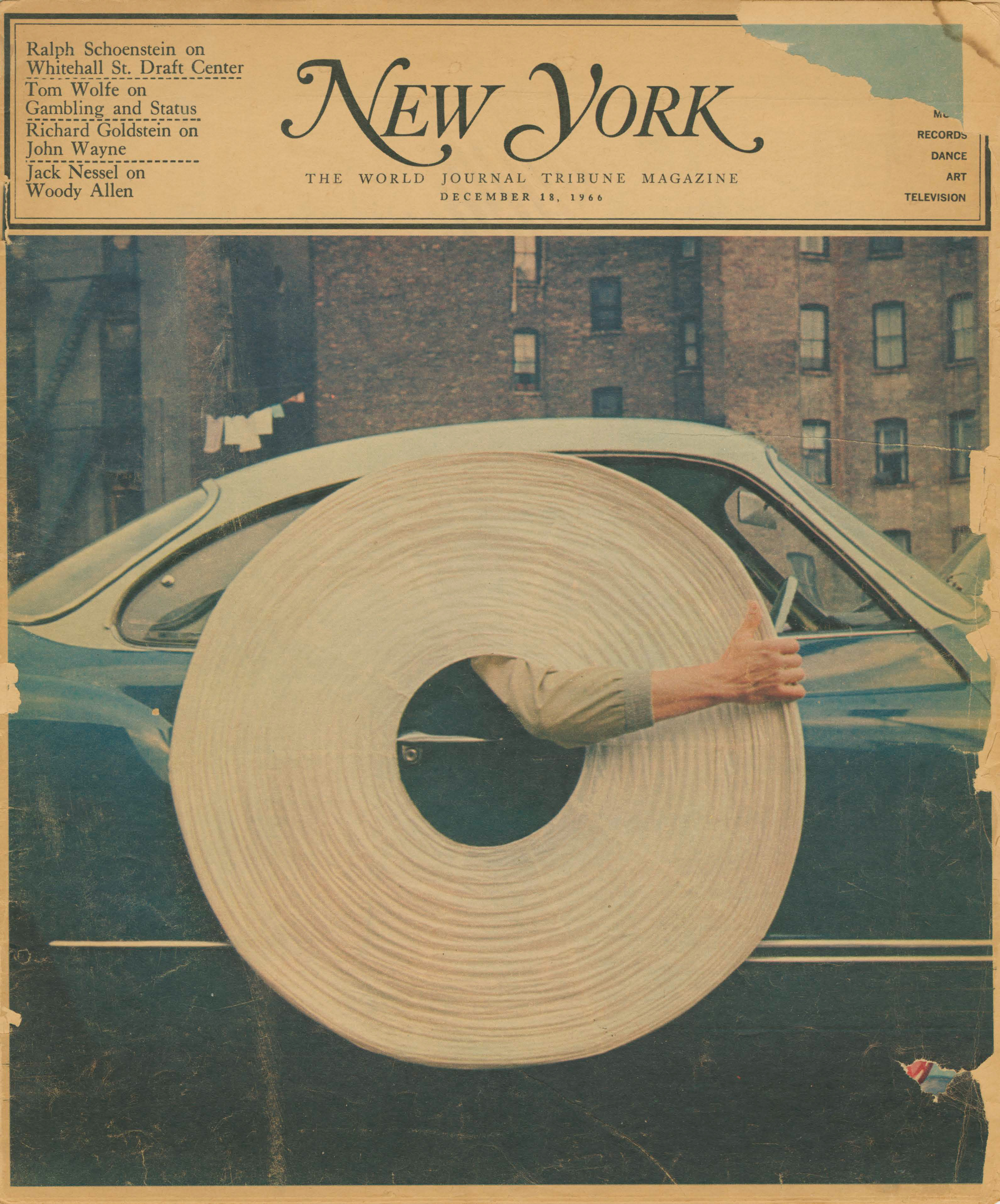 Archival magazine cover showing Isamu Noguchi's arm seen through the central hold of a folded flat lamp, held out of a car window