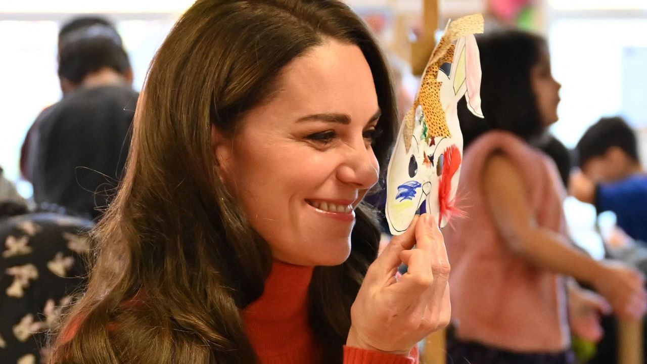 Britain&#039;s Catherine, Princess of Wales holds a mask to her face as she interacts with children during her visit to Foxcubs Nursery in Luton, north of London on January 18, 2023, as part of her ongoing work to elevate the importance of early childhood to lifelong outcomes.