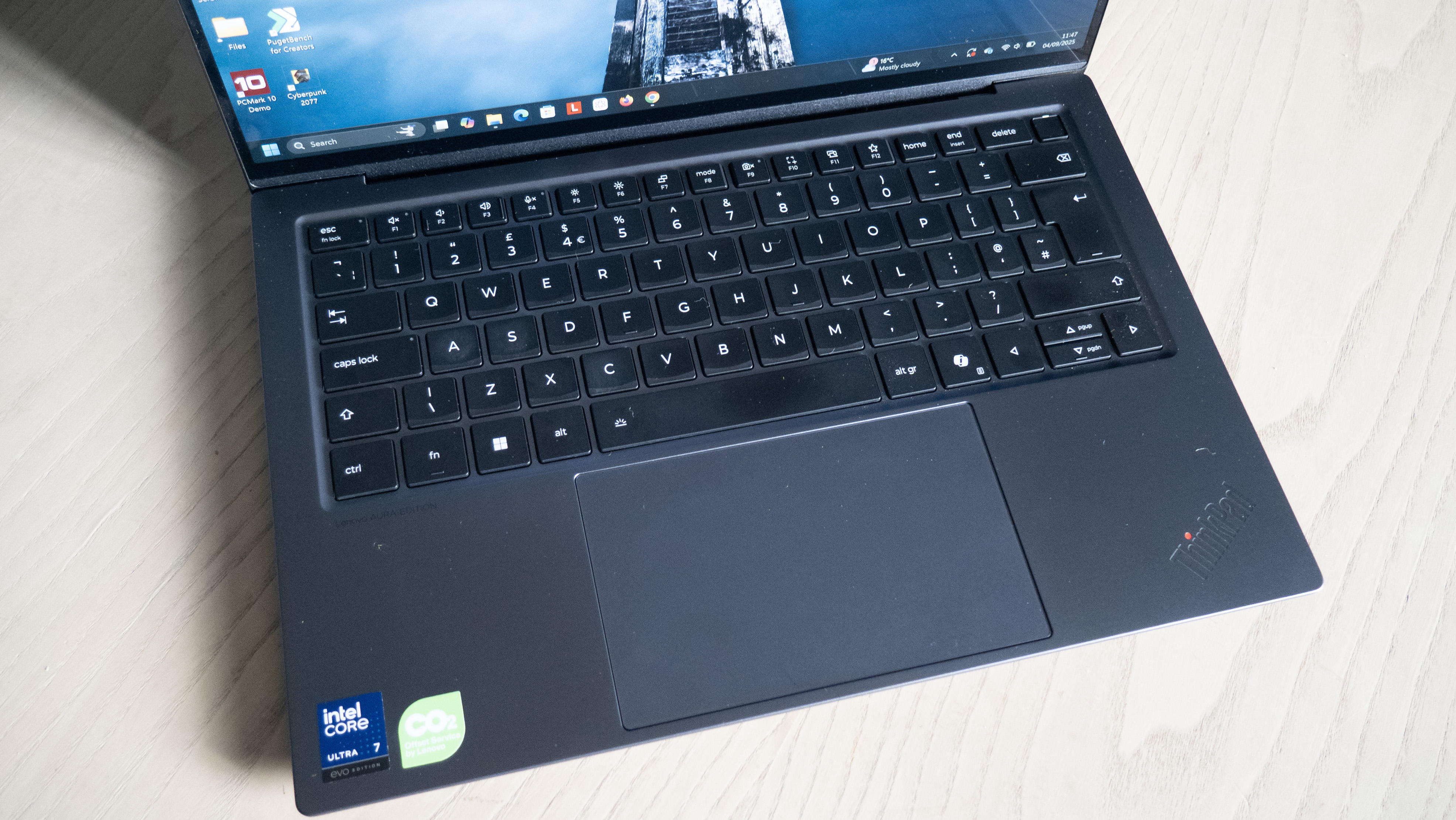A close up image of a Lenovo Thinkpad X9 Aura Edition laptop on a table