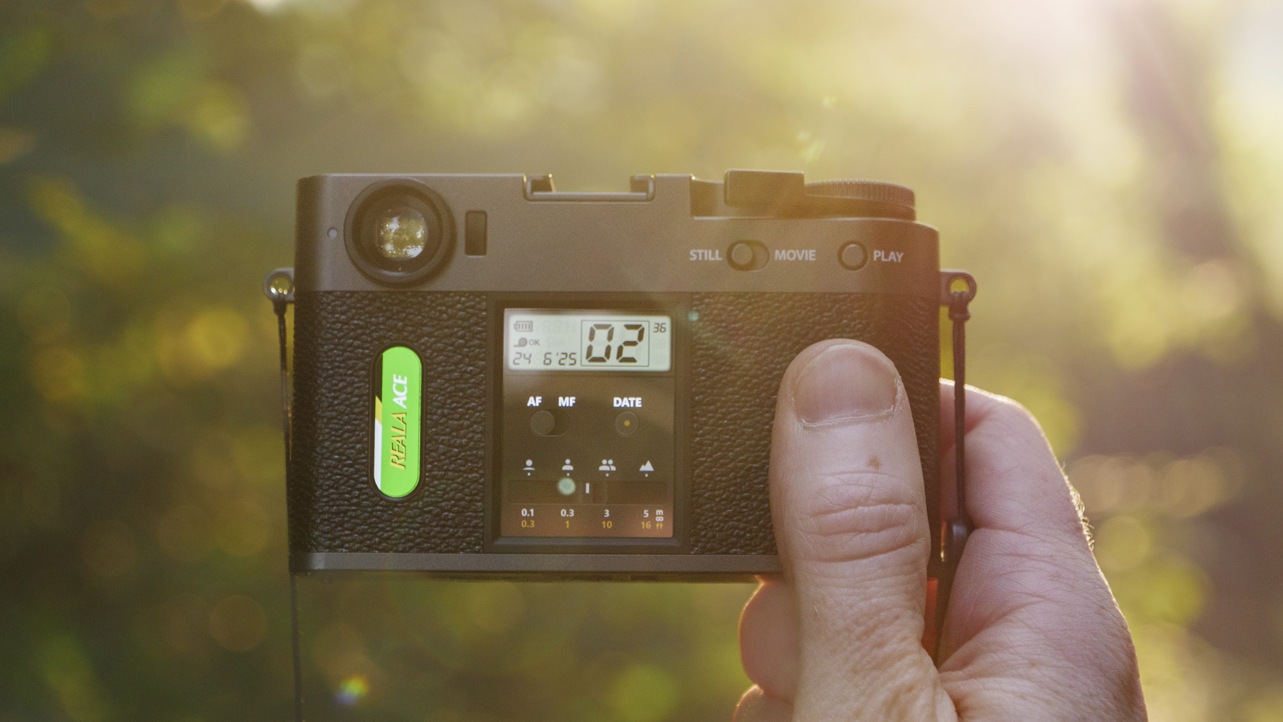 Fujifilm X half camera in the hand at golden hour