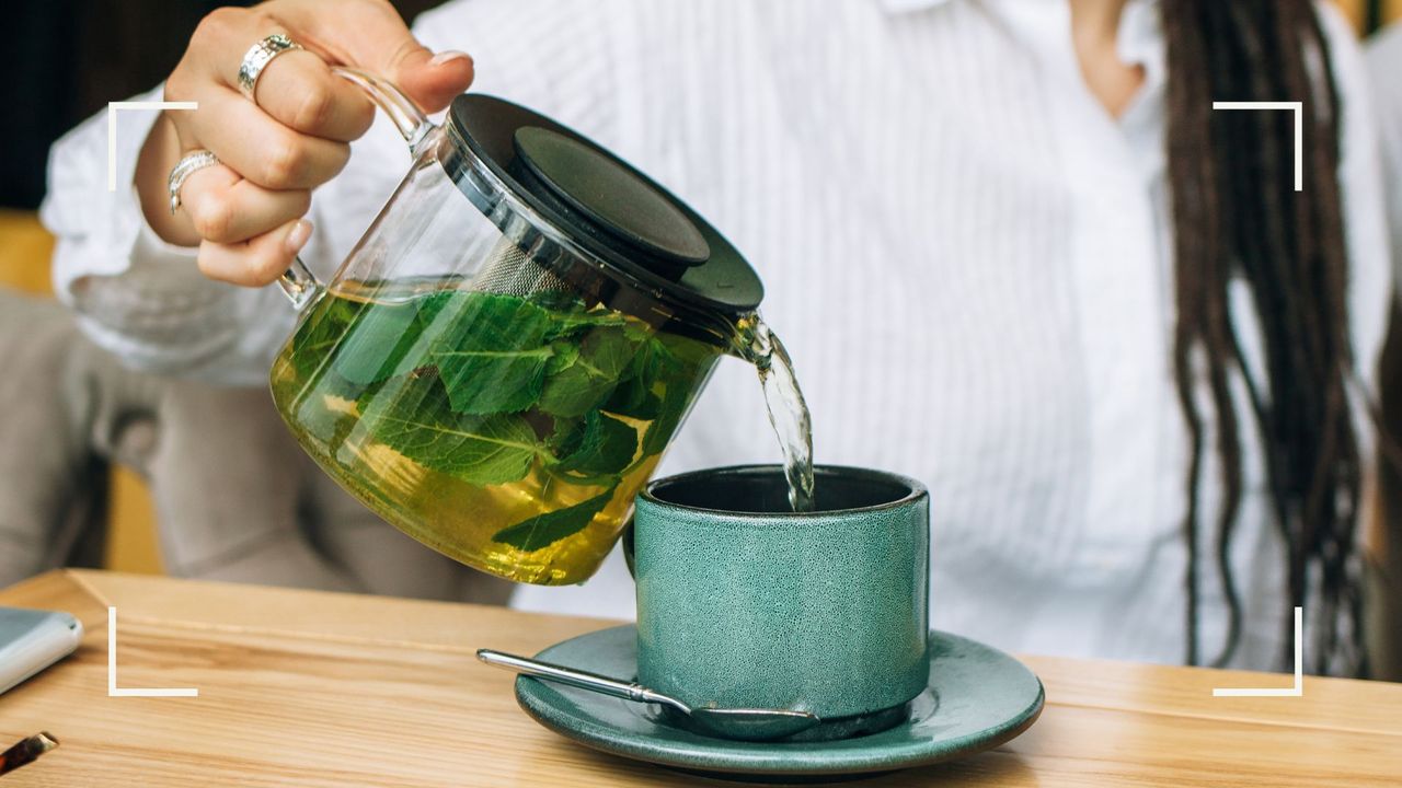 Woman pouring fresh green tea from glass jug into ceramic cup, representing the question of can green tea help you lose weight