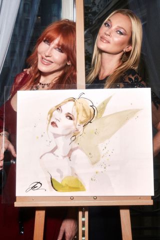 Charlotte Tilbury and Kate Moss posing together with a portrait of Kate Moss