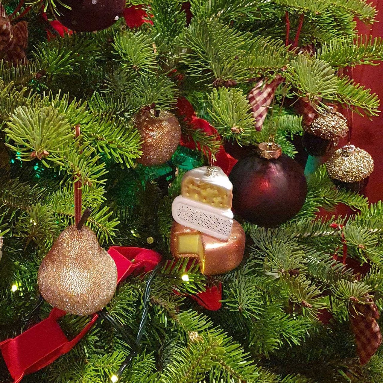 A Christmas tree decorated with M&amp;S baubles, including a stack of cheese, taken at the brand's Christmas 2026 press show