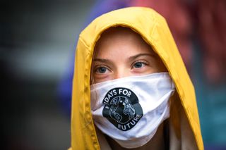 Greta Thunberg, who is wearing a face mask in the picture