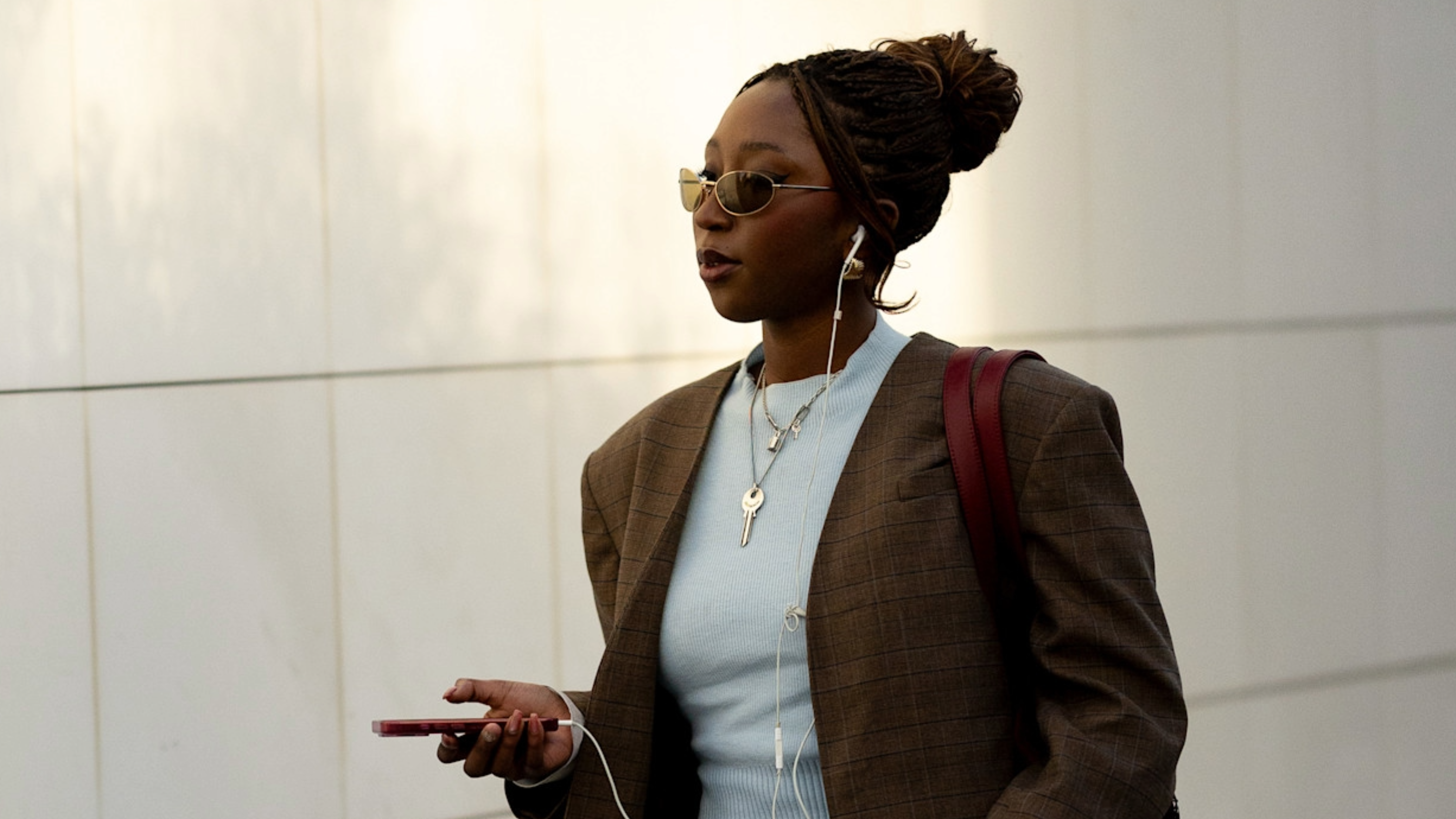 woman wearing a blue t-shirt and a brown blazer