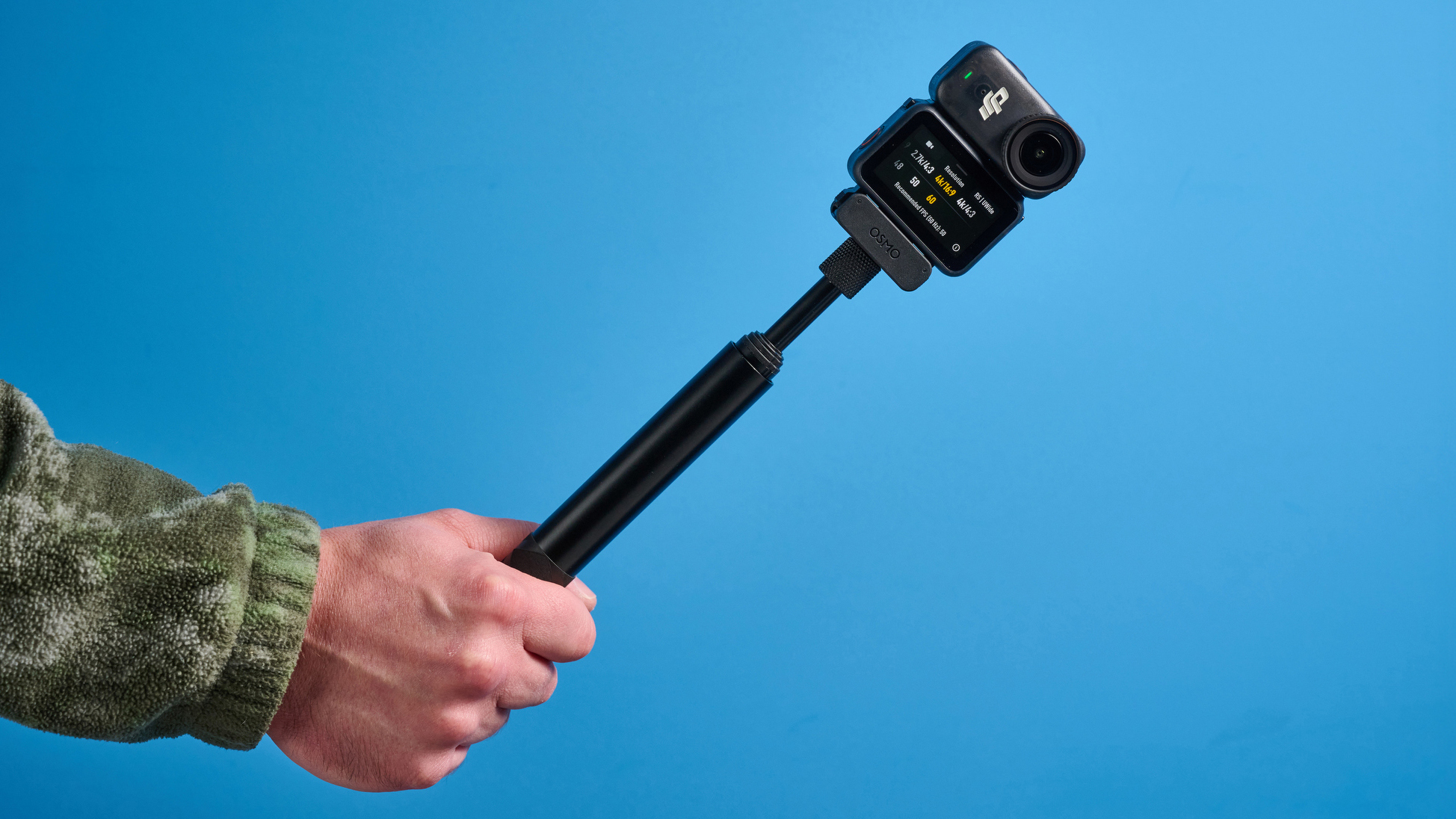 DJI Osmo Nano in hand on a selfie stick