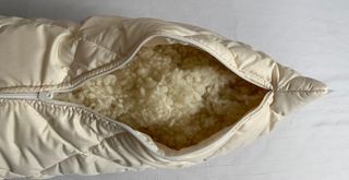 woolroom pillow unzipped to show the wool filling inside