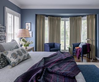 Michigan bedroom with blue walls and chairs