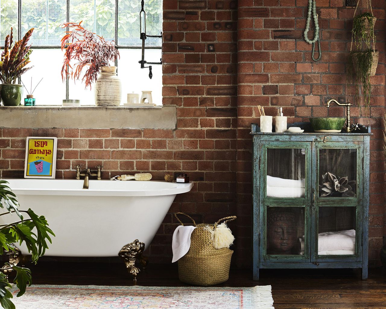 Bathroom with exposed brick wall decor, rustic bathroom counter and white bathtub