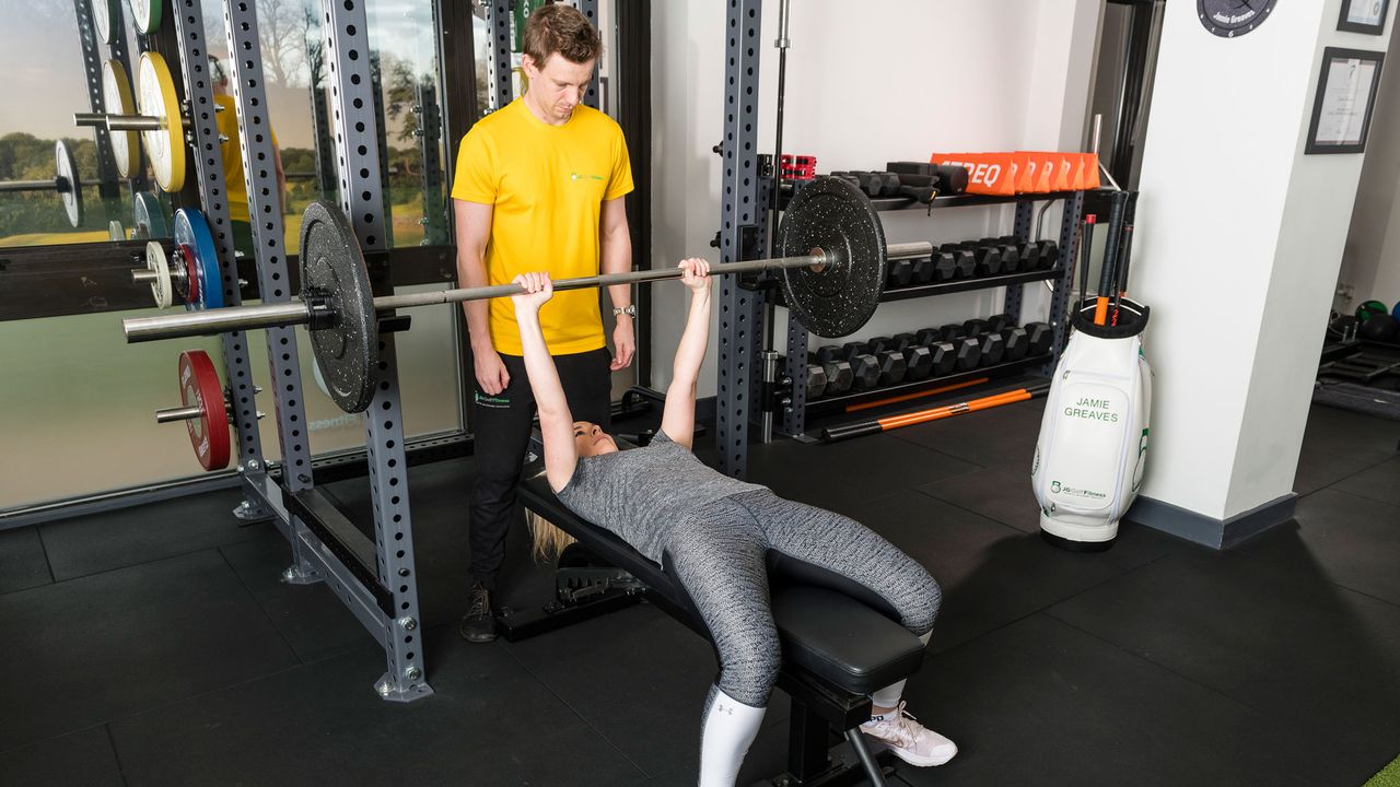 Golf Strength Training: Fitness Guru Jamie Greaves coaching a participant through a barbell press