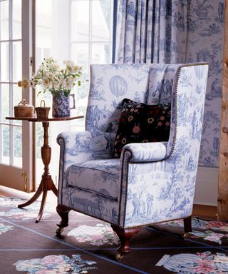 Armchair upholstered in a blue and white toile fabric