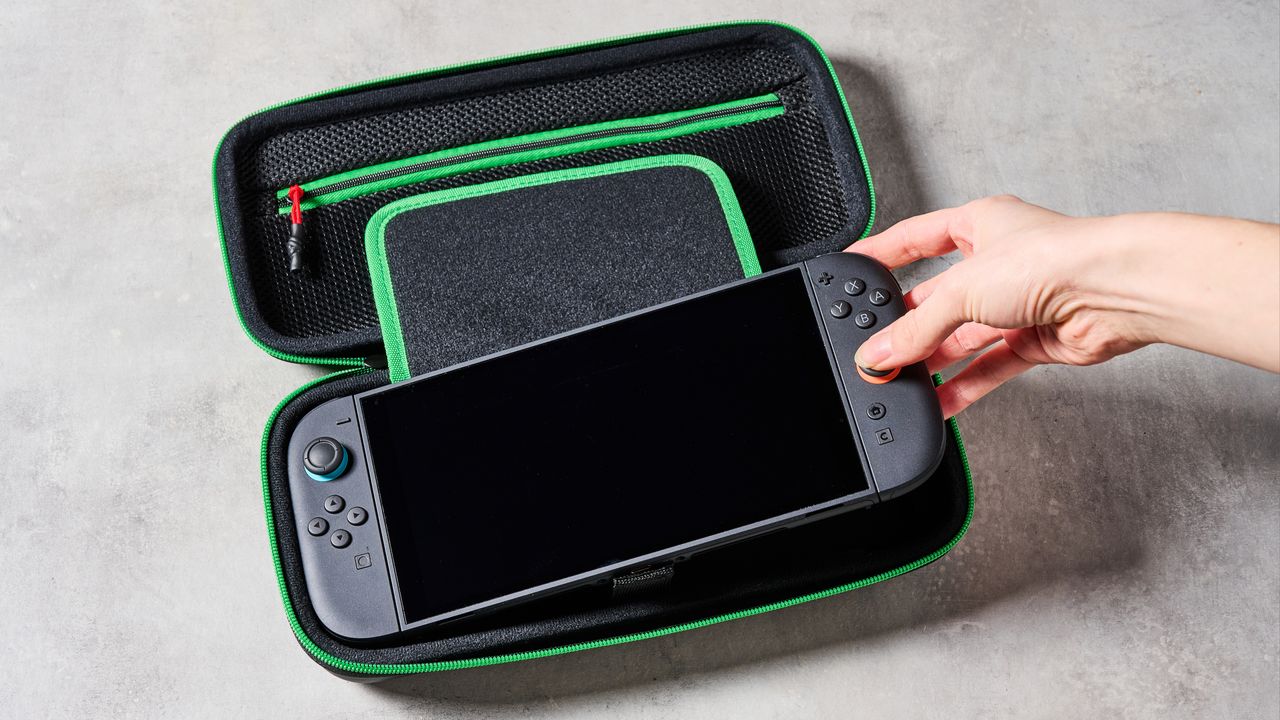 Person placing Switch 2 console into the Turtle Beach PlayTrek Travel Case for Nintendo Switch 2