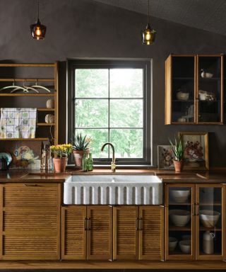 White sink in dark painted kitchen