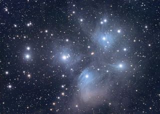The Pleiades star cluster: A gathering of galaxies connected by filaments of gas and dust.