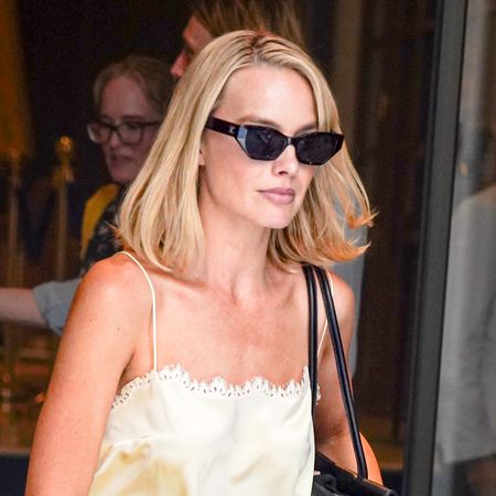 Margot Robbie wears a butter yellow lingerie-style Doen set with hybrid Mary Jane ballet flats in Paris