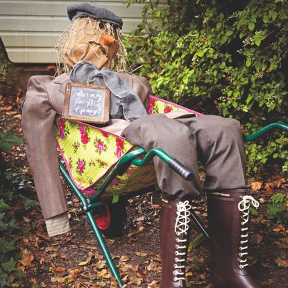A scarecrow in a wheelbarrow