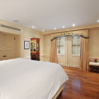 two master size bedroom with hardwood floors and wooden flooring