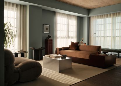 view of a canada water Penthouse at The Founding by Conran and Partners, including timber based furniture and warm colours under moody lighting