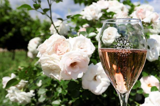 glass of rose prosecco with roses