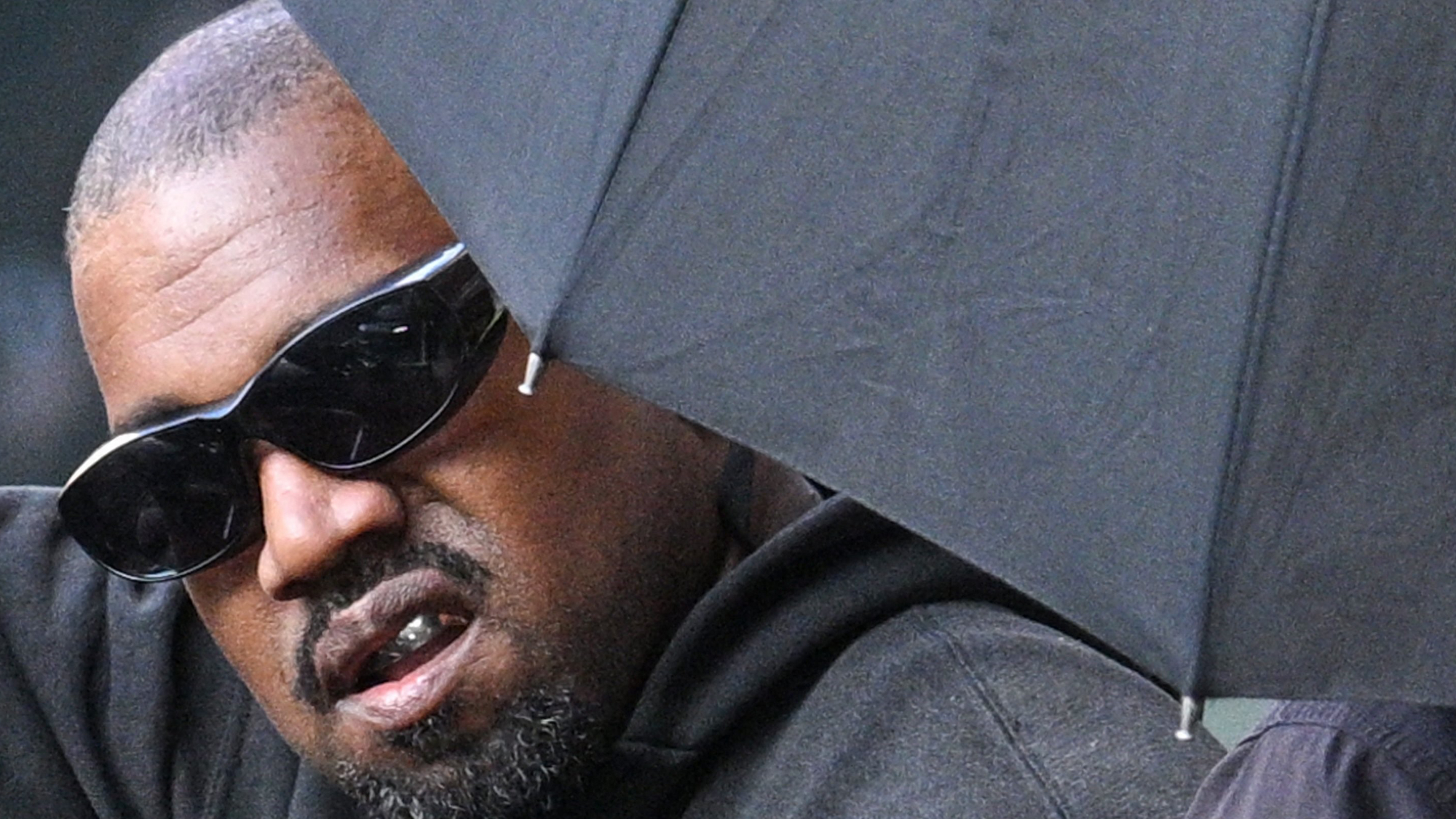 US rapper and producer Kanye West gestures upon arriving at Shanghai Pudong International Airport on July 11, 2025