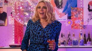 Busy Philipps in a blue leopard dress in Girls5eva season 3