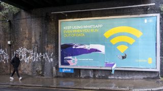 Poster for the mobile phone and telephone service provider brand EE advertising that you can still access WhatsApp even if you have run out of phone credit on 8th March 2023 in London, United Kingdom.