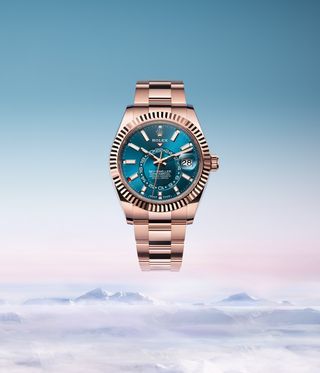 rolex watch with blue dial, against cloud and sky backdrop: Rolex Perpetual Sky-Dweller