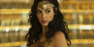 Wonder Woman (Gal Gadot) wears her costume in front of a blurry gold backdrop in an image from 'Wond