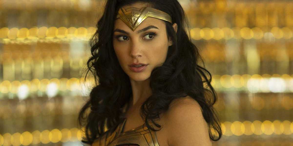 Wonder Woman (Gal Gadot) wears her costume in front of a blurry gold backdrop in an image from &#039;Wond