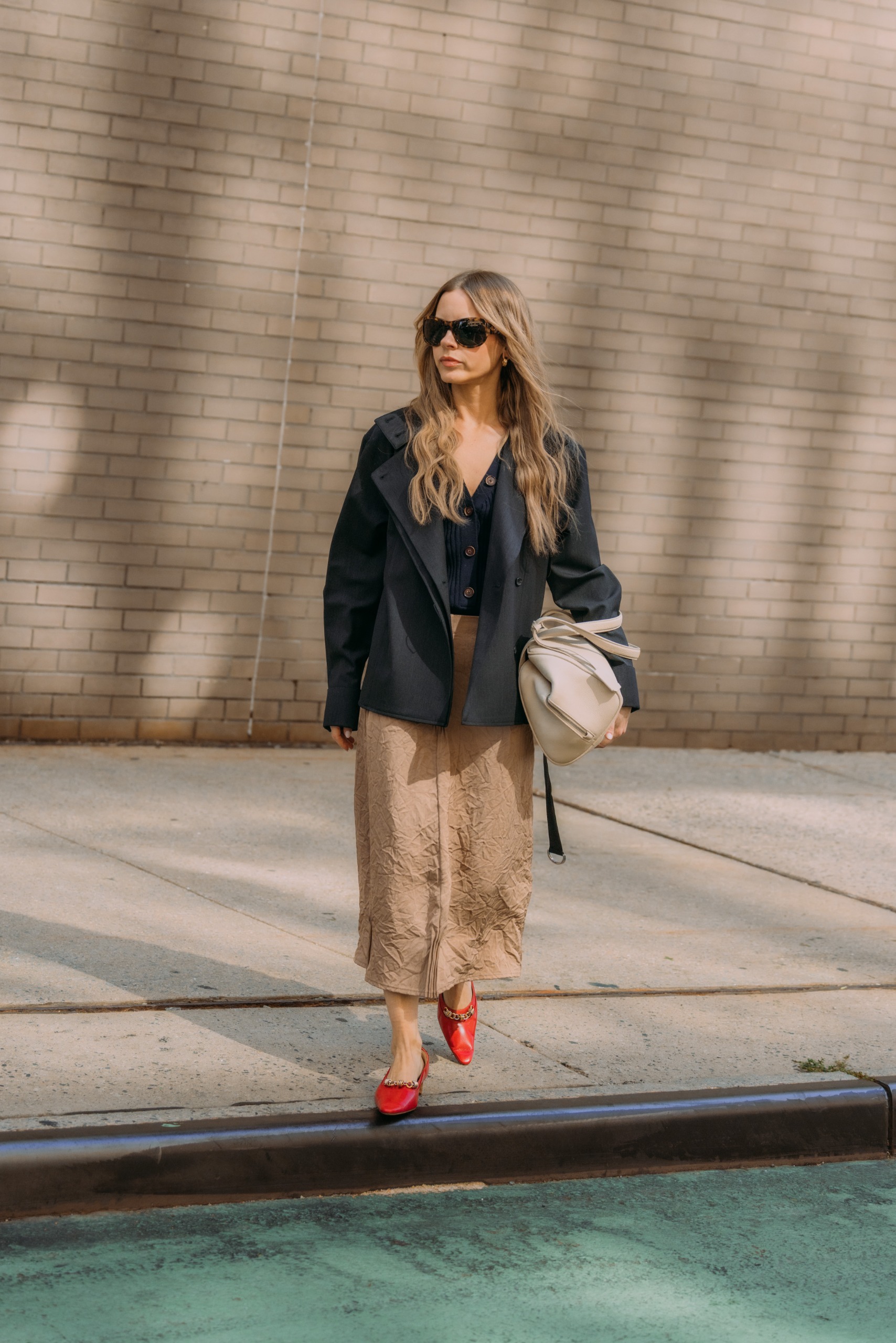 Nikki Chwatt wearing red Tory Burch Chain Pumps during New York Fashion Week.