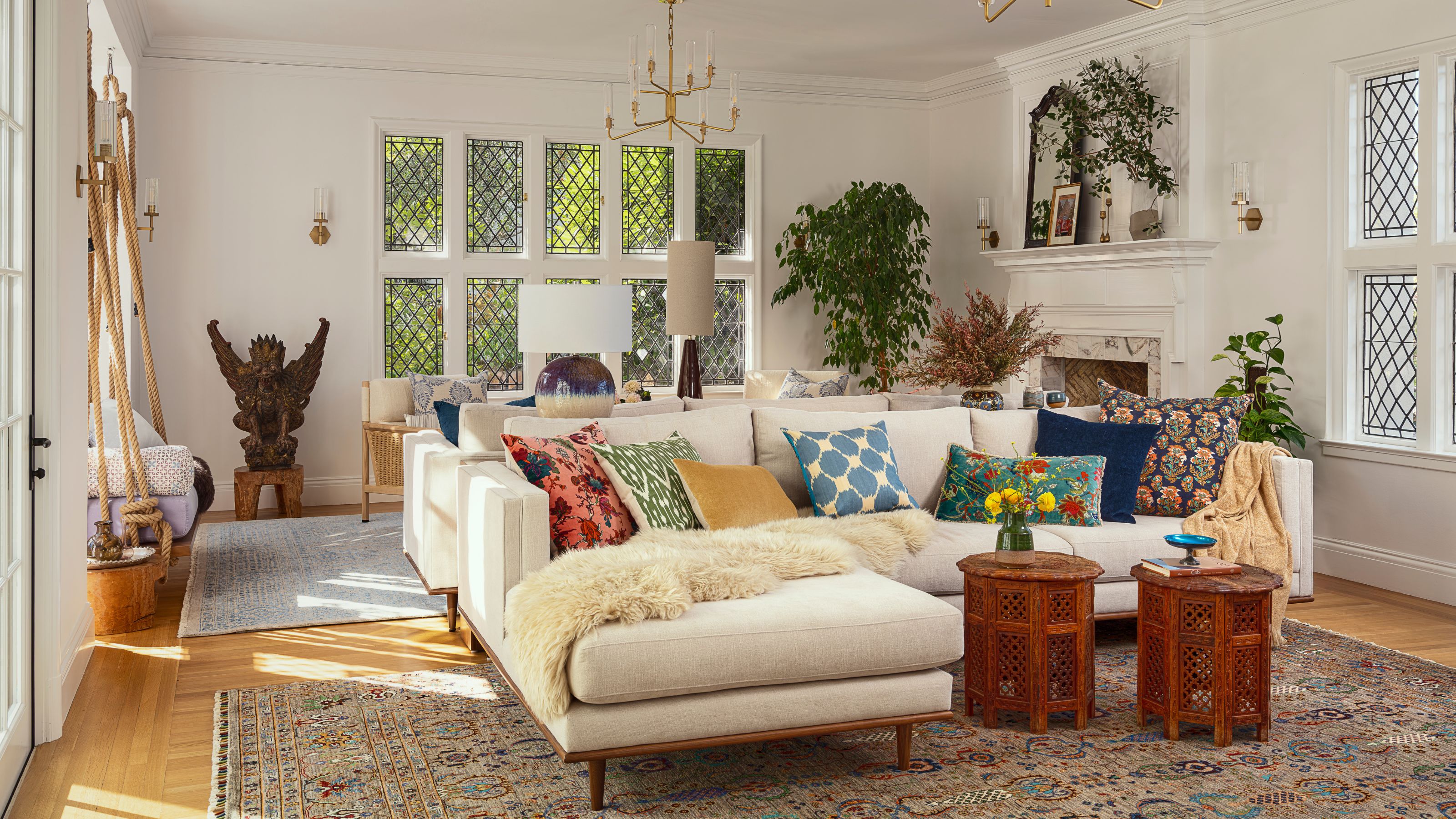 a white painted living room in a tudor home with original windows and fireplaces