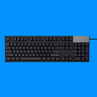 Topre Realforce R2 keyboard on a blue background.