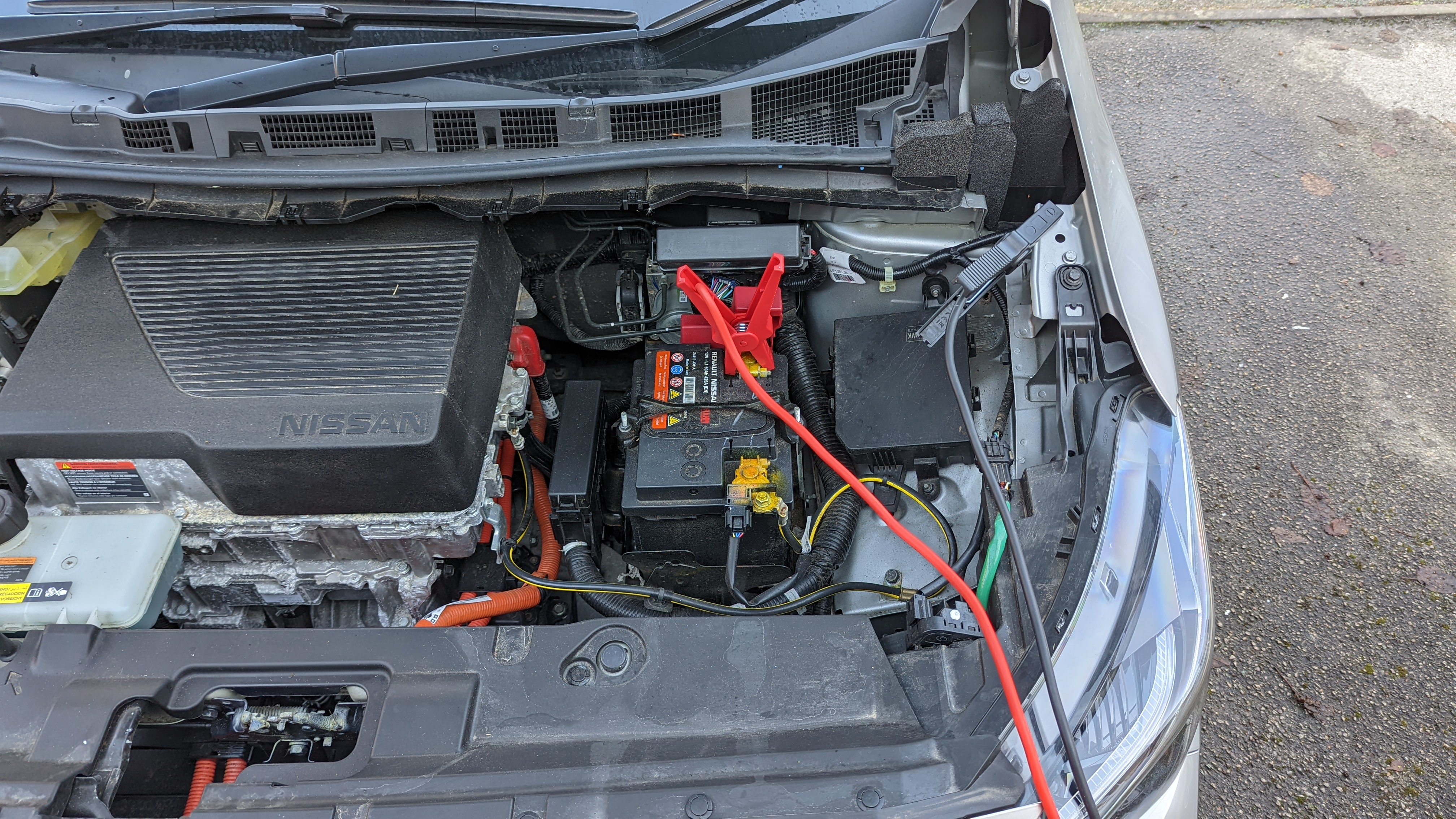 Nissan leaf with jumper cables attached to 12v battery