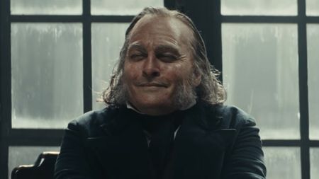 Johnny Depp's Ebeneze smiling and squinting after not donating to charity. 