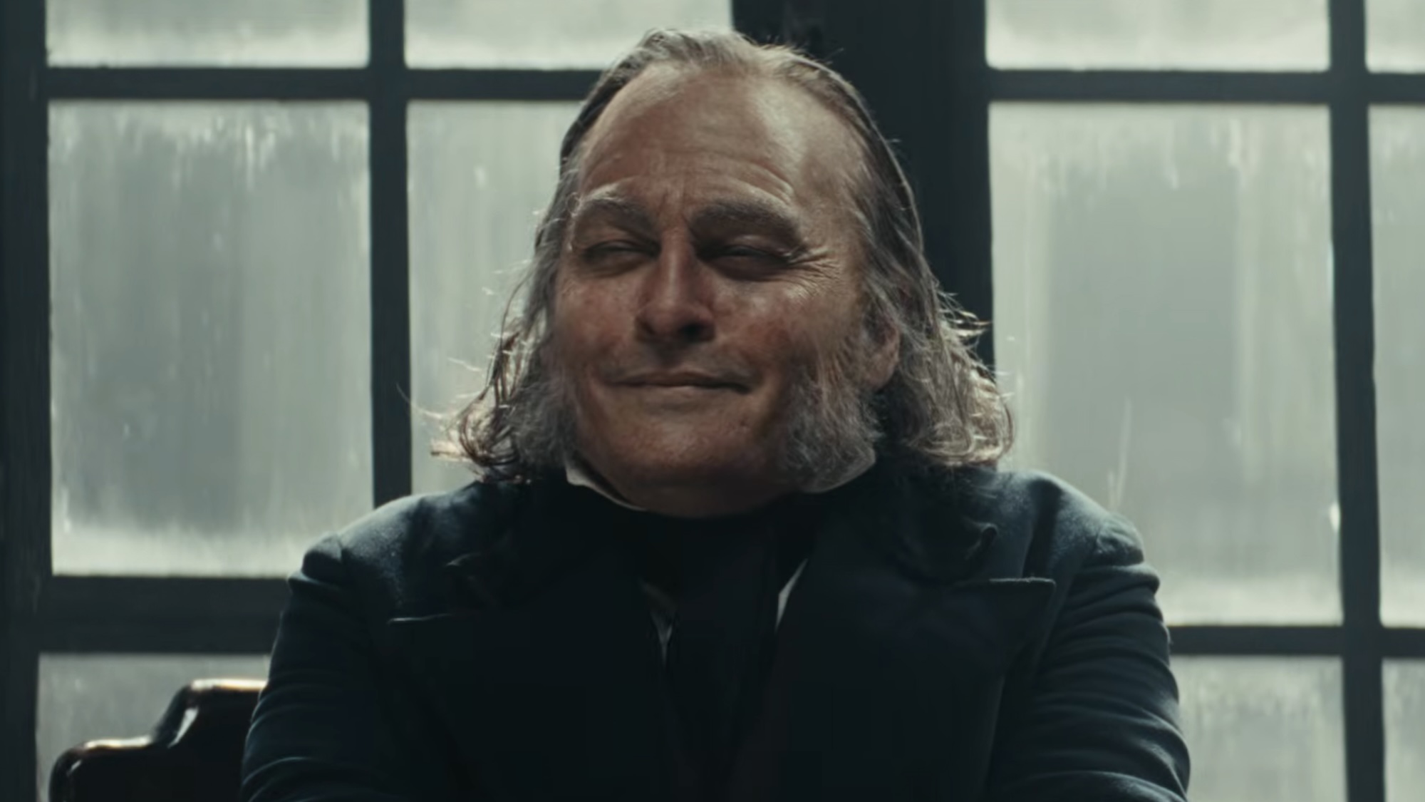 Johnny Depp's Ebeneze smiling and squinting after not donating to charity. 