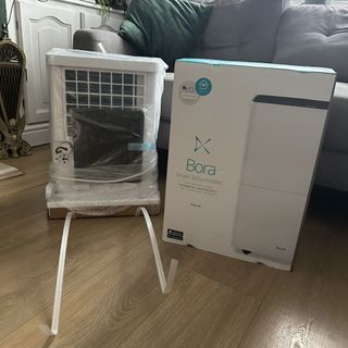 The Duux Bora Smart dehumidifier unboxed in a living room with a wooden floor