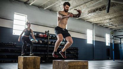 Plyometric exercises being performed by a man and woman (box jump)