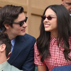 Olivia Rodrigo and boyfriend Louis Partridge attended Wimbledon2025 in a red gingham mini dress.
