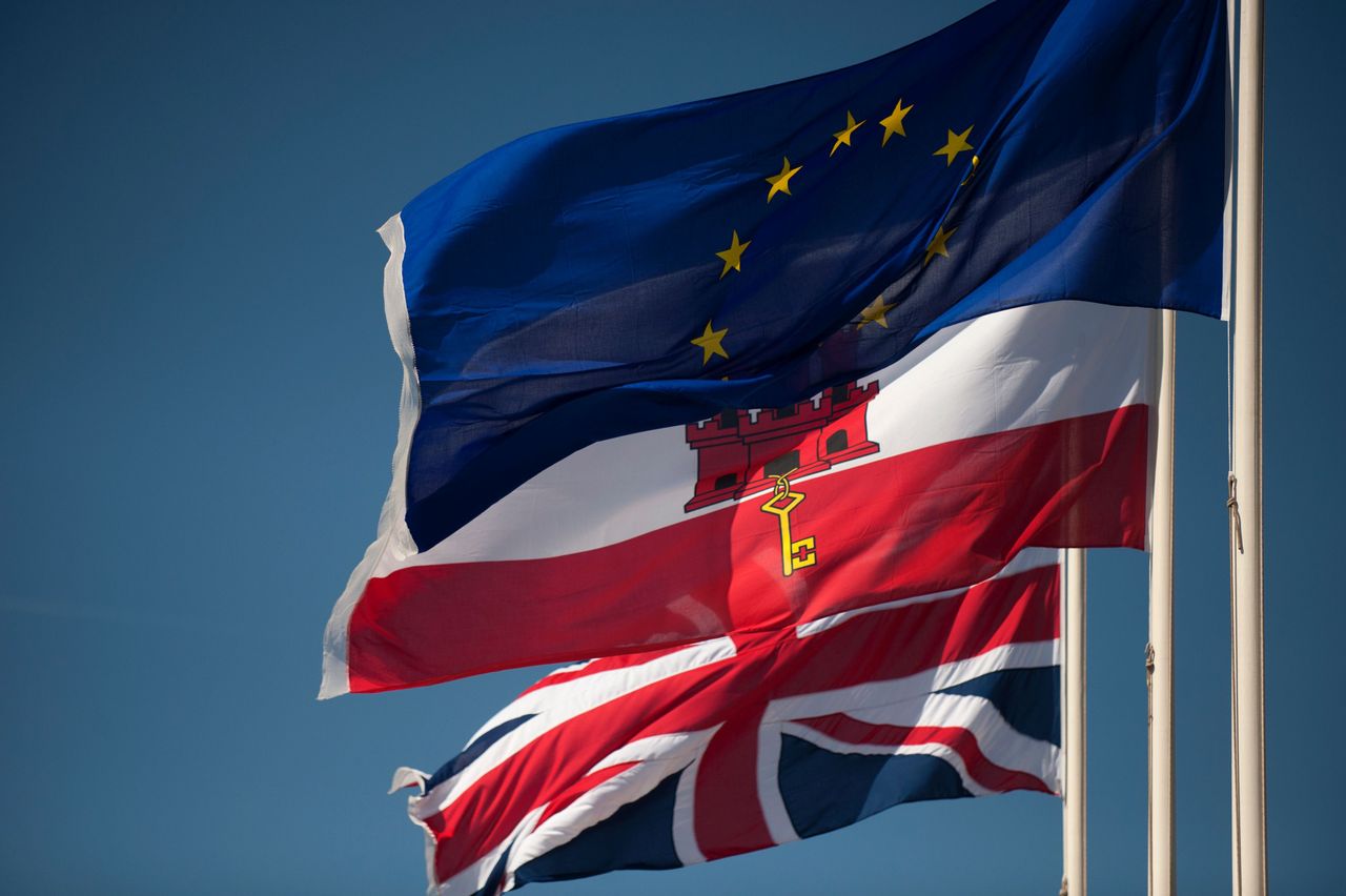 A Union Jack flag, Gibraltar&amp;#039;s flag, and the EU flag